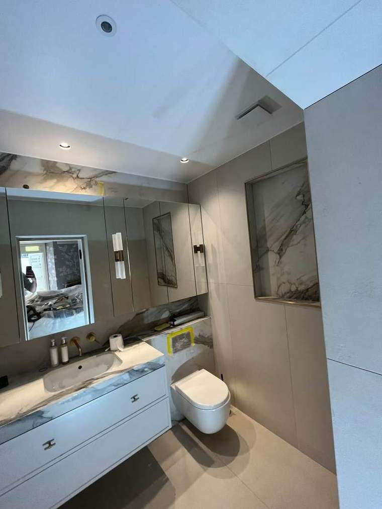 Marble bathroom with mirrored cabinet and fitted vanity