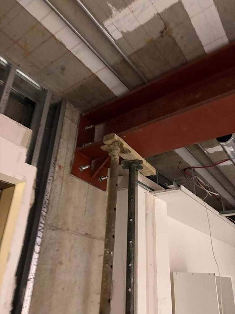 Steel beam bearing onto a padstone with propping beneath