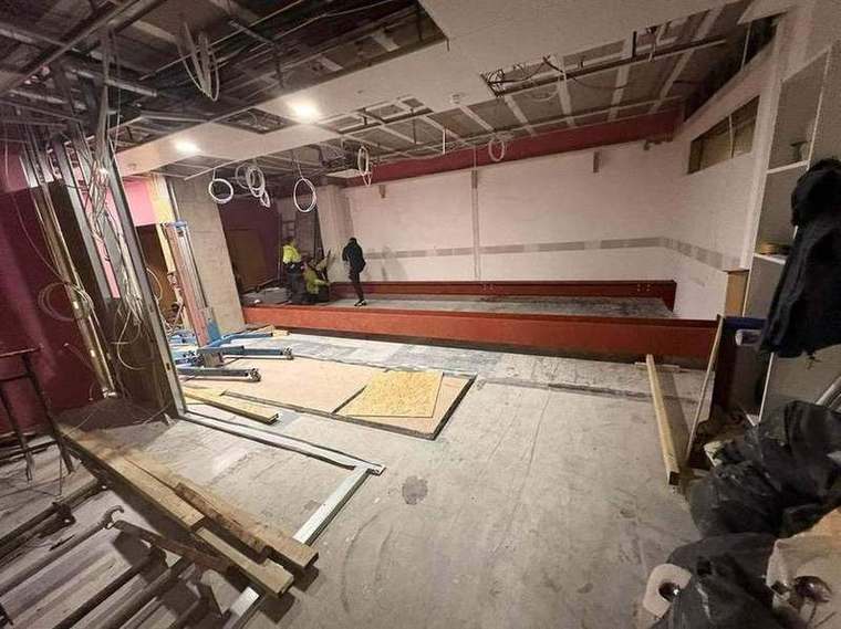 Steel beam positioned along the wall ready to lift