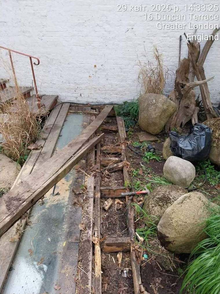 Decking boards lifted showing decayed timber beneath