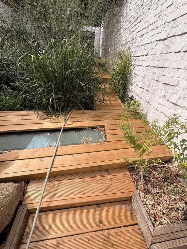 Decking scribed around a planted bed of grasses