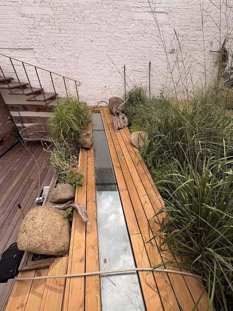 The rebuilt garden seen from above with seating and grasses