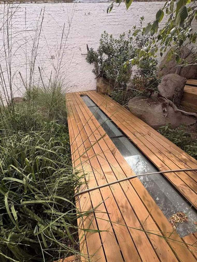 Walk-on glass strip framed by new decking and grasses