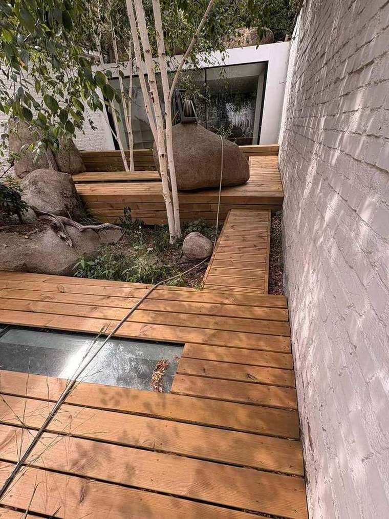 Timber steps set between boulders and birch trees
