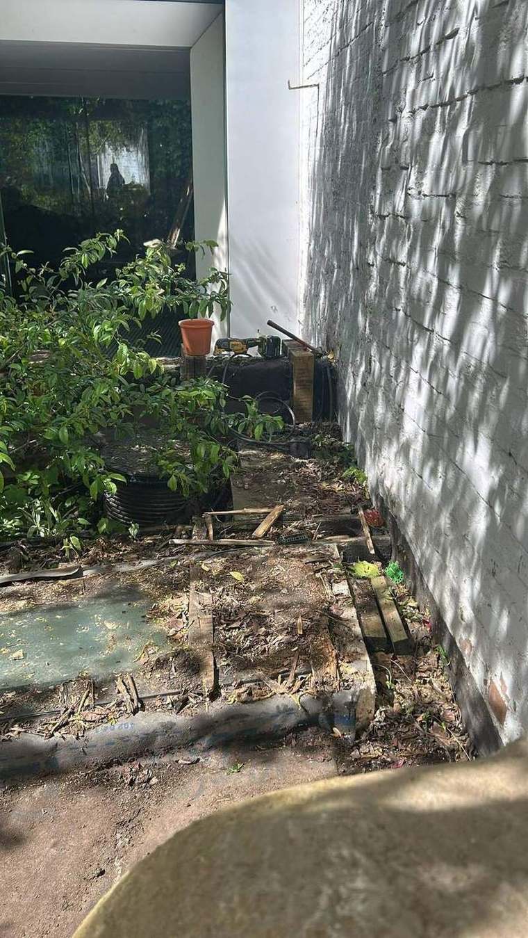 Terrace stripped back to the membrane against the boundary wall