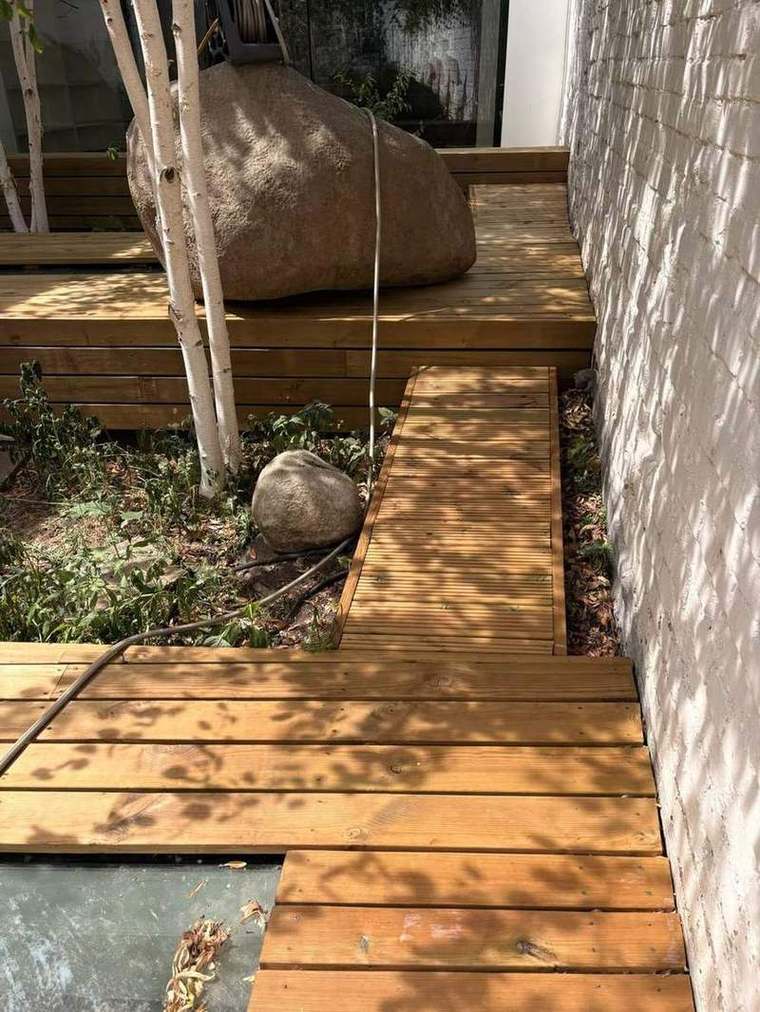 Raised timber walkway along the boundary wall