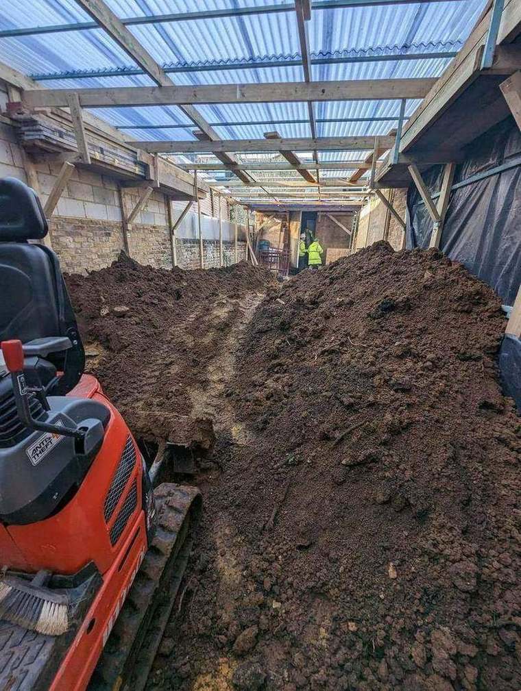 Basement excavation and spoil under a covered scaffold