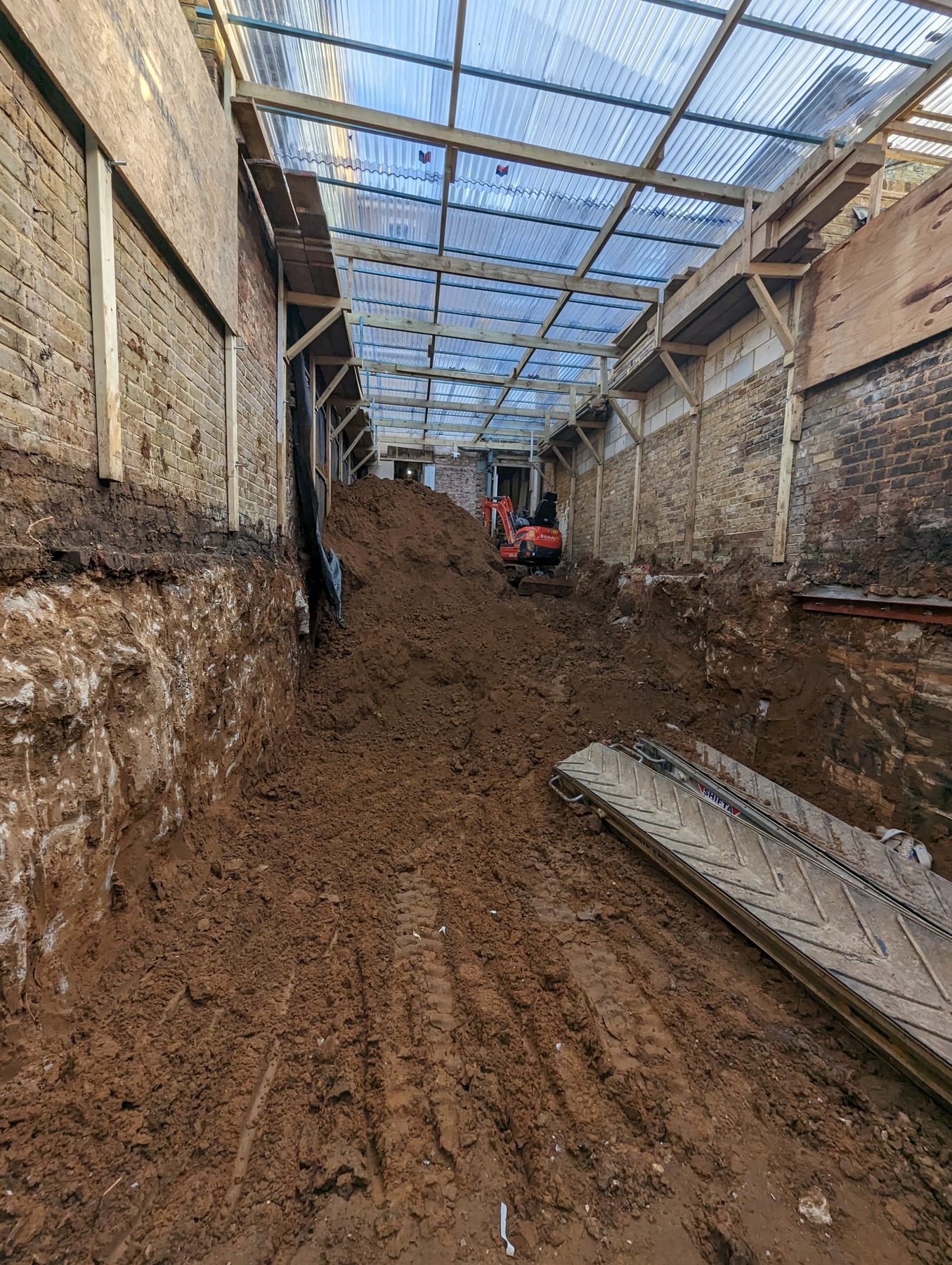 Deep basement trench excavated by machine