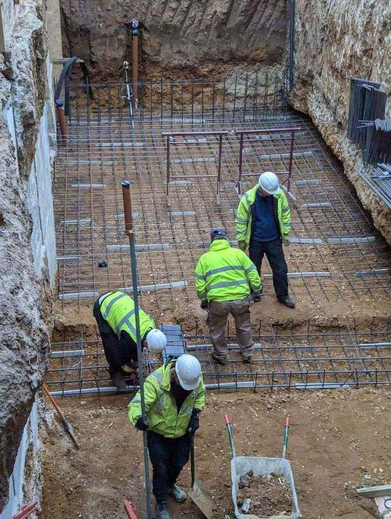 Site team fixing steel reinforcement for the basement slab