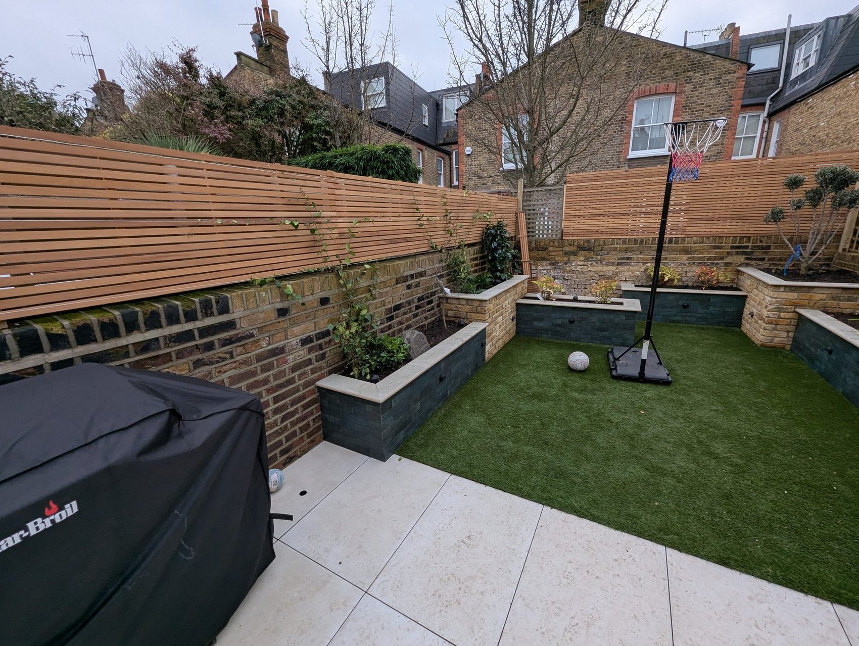 Landscaped rear garden with raised beds and terrace