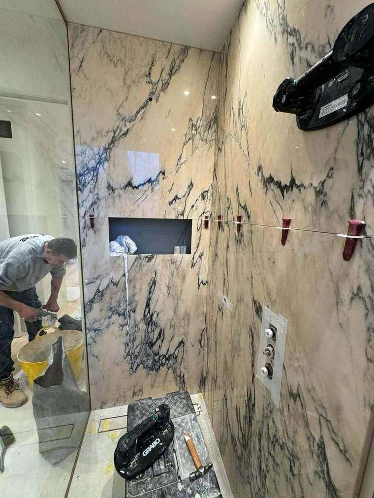Marble slabs being installed in a bathroom