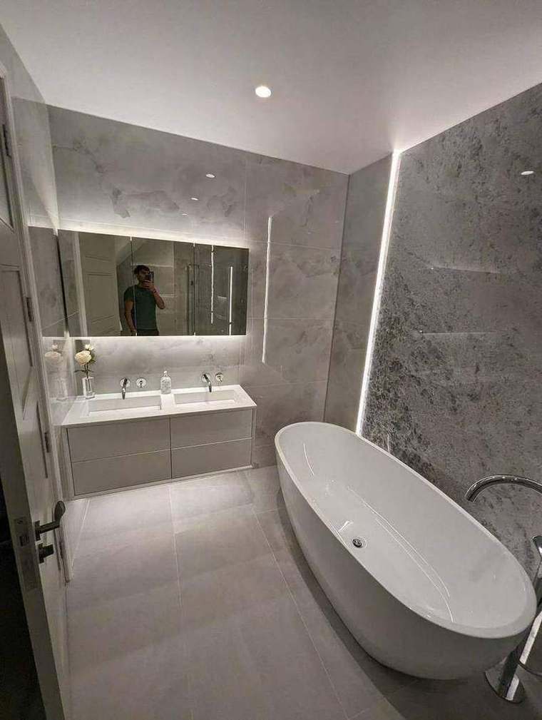 Principal bathroom with freestanding bath and marble walls