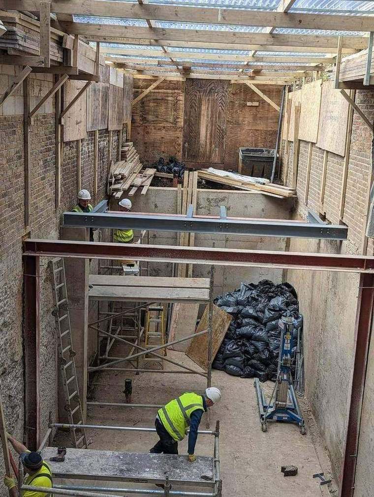 Structural steel beams installed at the rear of the house