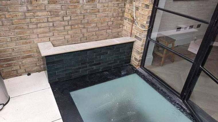Walk-on glass panel in the garden above the new basement